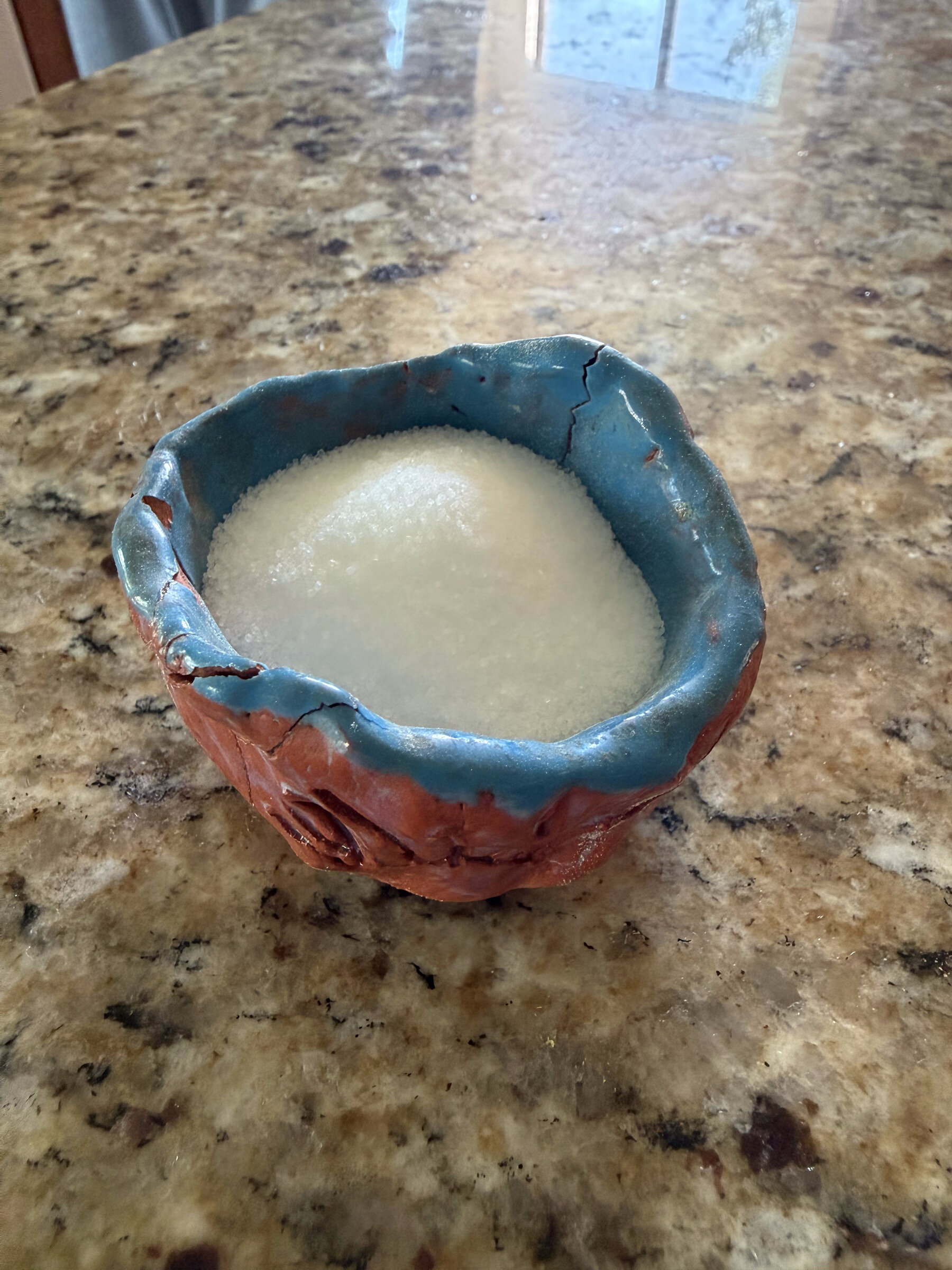 A glazed pinch-pot bowl, now used to hold salt at the table
